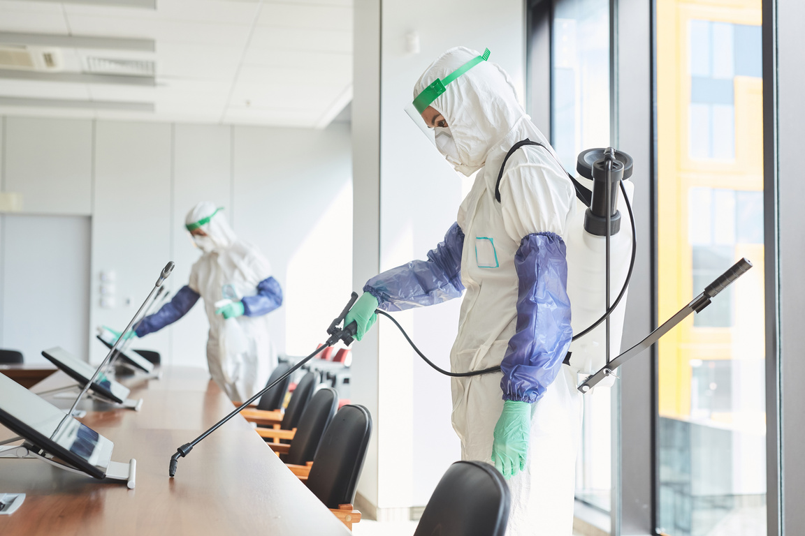 Workers Disinfecting Conference Room